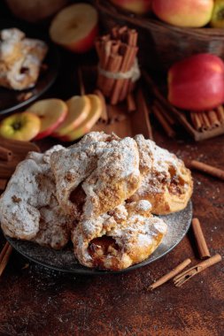Elma ve tarçınlı ev yapımı mini elmalı turtalar. Üzerine pudra şekeri serpiştirilmiş taze pişmiş yiyecekler. Viyana pastası.