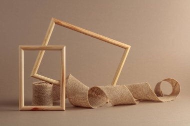 Ahşap çerçeveler ve bej arka planda çuval bezi kurdelesi. Doğal organik ürün, marka kimliği ve ambalaj için arka plan. Boşluğu kopyala.