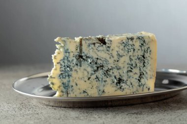 Gri taş bir masada Gorgonzola peyniri. Boşluğu kopyala.
