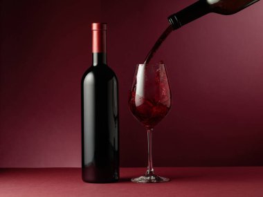 Kırmızı arka planda kırmızı şarap. Boşluğu kopyala.