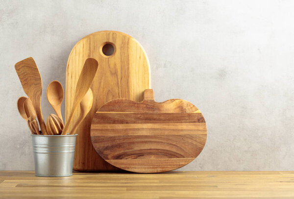 Wooden kitchen utensils on a wooden table. Copy space.