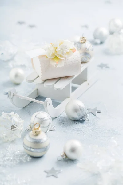 Noel Süsleri Toplar Gümüş Karlı Beyaz Kızak Üzerinde Küçük Hediye — Stok fotoğraf