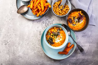Carrot and sweet potato soup with chickpeas and fresh winter herbs, sweet potato fries