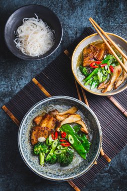 Ramen soup  with mushrooms, vegetables, glass noodles and  pork