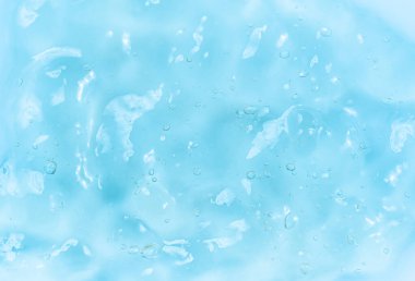 Clear gel serum texture. Liquid skincare cream background. Cosmetic gel product with bubbles close up