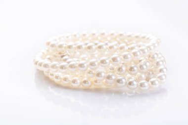 Pearl necklace on white background with copy space