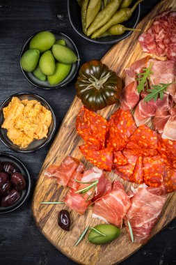 Charcuterie board with prosciutto ham, salami, olives and tapas