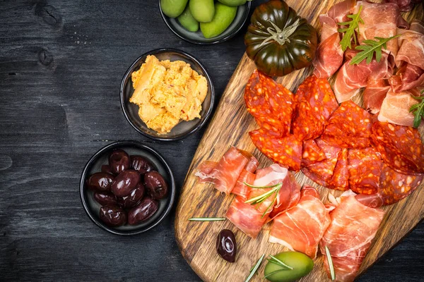 stock image Charcuterie board with prosciutto ham, salami, olives and tapas