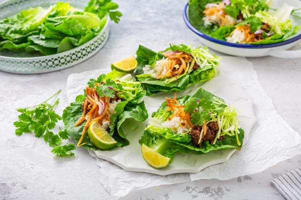 Asian minced meat lettuce wraps with rice, bean sprouts and cabbage