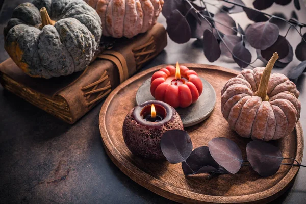 Fall candle decoration with  pumpkins, wooden home decor still life scented candle, autumn season interior decoration details