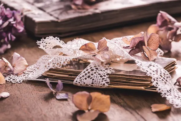 Memories, antique and old family photos with  dried flowers in vintage style on wooden table