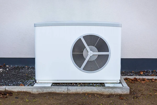 Air source heat pump installed outside a house, green renewable energy concept of heat pump