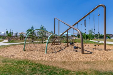 Large public city playground with slides and climbing frame, panorama of modern urban area