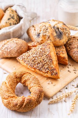 Variation of bread rolls or buns with butter and assorted seeds with breadbag clipart