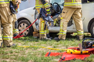 Eğitim sırasında gönüllü itfaiyeciler, kazadan sonra arabadan manken kurtarma.