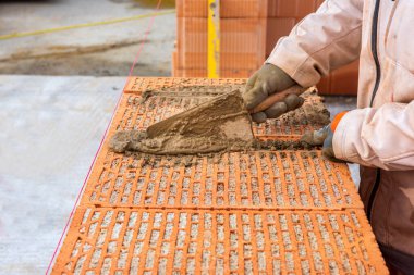 bricklayer at work at new house in construction