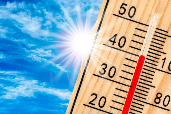 thermometer shows high temperature in summer heat with dryness and lack of water in field