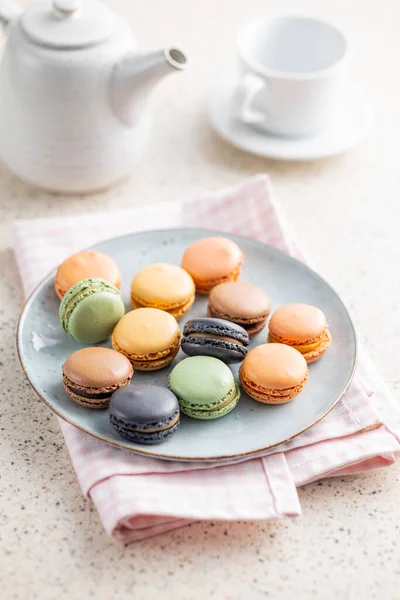 stock image Sweet macaron dessert. Colorful macarons on plate on the checkered napkin.