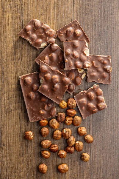 Broken Chocolate Bars Nuts Wooden Table Top View — Stock Photo, Image