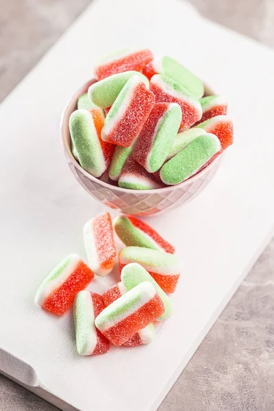 Watermelon jelly candies in bowl on the kitchen table.