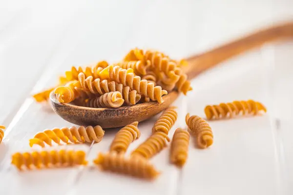 Raw Whole Grain Fusilli Pasta Uncooked Pasta Wooden Spoon — Stock Photo, Image
