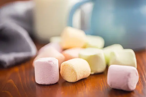 Sweet marshmallows candy on the kitchen table.