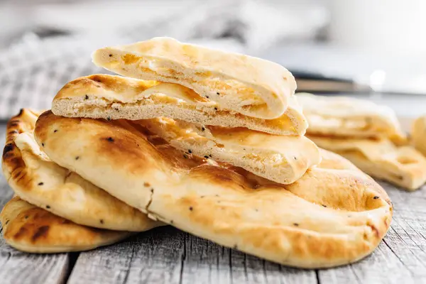 Freshly Baked Naan Bread on a wooden table