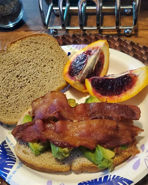 アボカドとベーコンのサンドイッチにオレンジの血が入った家庭料理 — ストック写真
