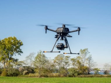 Brooklyn, NY, USA - October 29, 2022: Sony presented a new professional Drone Airpeak S 1 -  world smallest drone that can carry a full frame Alpha series mirrorless camera at Calvert Vaux Park. clipart