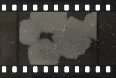 Damaged celluloid filmstrip. Splots, dust and scratches. Grunge background. clipart