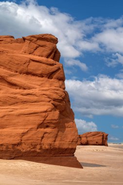 The red cliffs and beach of Havre aux Maisons, on the Gulf of St Lawrence, Iles de la Madeleine, Canada. Summer sky background. clipart