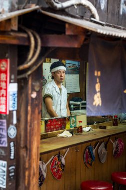 Tokyo, Japan - 27th June 2016: One of the small cafes of Omoide Yokocho, or Memory Lane, in Shinjuku, Tokyo. This area used to be called Piss Alley, as there were no toilets built until 1999. clipart