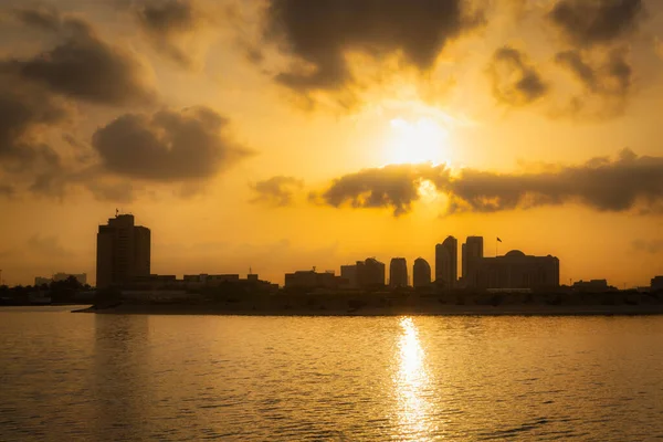 stock image Sunset in Abu Dhabi with skyscrapers silhouetted over the Persian Gulf, UAE