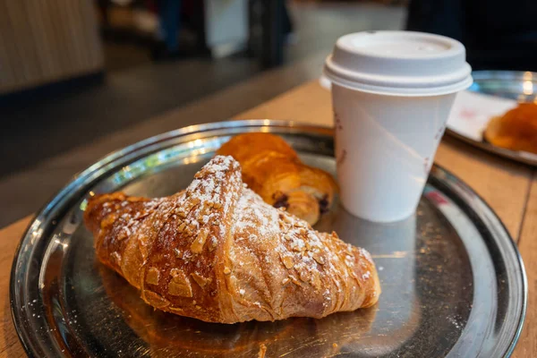 Coffee break with fresh croissant in Paris