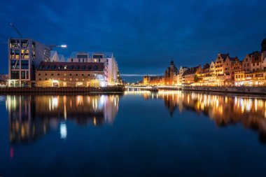 Old town in Gdansk with historical architecture by the Motlawa river at night, Poland.
