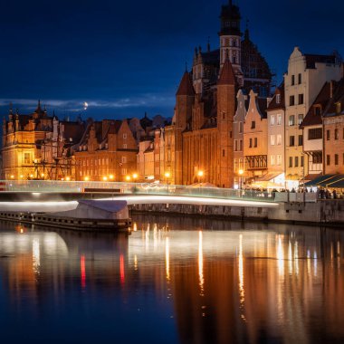 Old town in Gdansk with historical architecture by the Motlawa river at night, Poland.