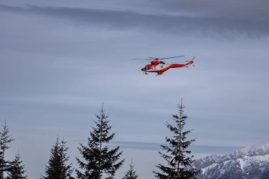 Zakopane, Poland - January 6, 2023: Rescue TOPR helicopter in the winter Tatra Mountains, Poland