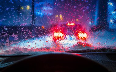 Wet and snowy winter seen through the windshield of a car
