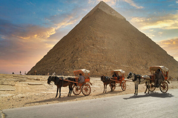 Cart with horses for rent under the pyramid of Khafre in Giza, Egypt