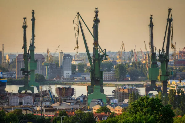 stock image Cranes of the shipyard in Gdansk at sunset, Poland