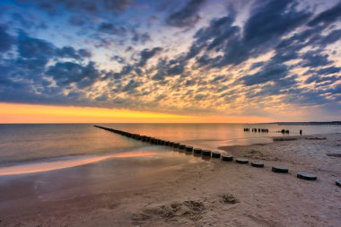 Beautiful sunrise on the summer beach at Baltic Sea in Ustka, Poland. clipart