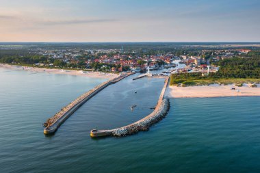 Beautiful sunrise over the Ustka harbour by the Baltic Sea, Poland. clipart