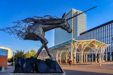 Lodz, Polonya - 24 Ağustos 2023: Tek Boynuzlu At Anıtı ve Lodz 'un merkezindeki renkli çatılı tramvay istasyonu Unicorn Ahırı. Polonya