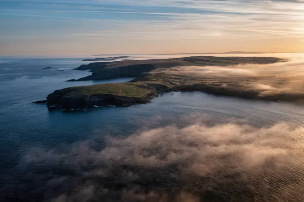 Misty Sunrise Yli Kivinen Rannikolla Kilkee Clare Irlanti tekijänoikeusvapaita kuvapankkikuvia