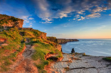 Beautiful sunset over the Cliffs of Moher in County Clare, Ireland. clipart