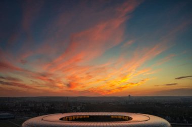 Gdansk, Poland - August 31, 2024: Aerial landscape with amber shape stadium - Polsat Plus Arena by the Baltic Sea in Gdansk at sunset, Poland. clipart