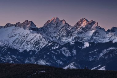 Ganok (2465 m), Vysoka (2559 m) and Rysy (2501 m) in the light of the rising sun in winter. High Tatras clipart