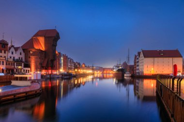 Gdansk 'taki Motlawa nehrinin kıyısındaki eski şehrin güzel mimarisi. Kış gecesinde tarihi bir iskele vinci var. Polonya