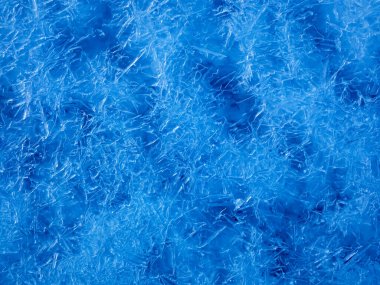 Close up of dark blue frosty pattern on ice