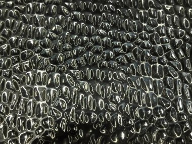 Repeating pattern on metal. Metal texture. Blurry reflections of light on a curved metal sheet. Abstract texture.